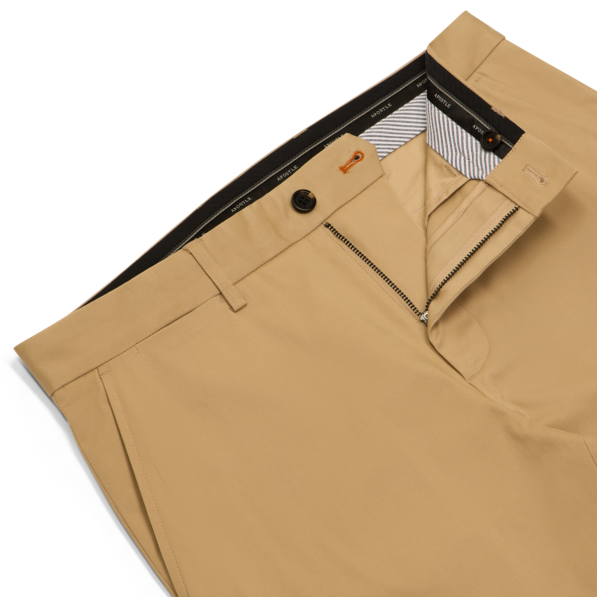 Close-up of tan chinos or dress pants showing the waistband, button closure, zip fly, and interior lining on a white background.